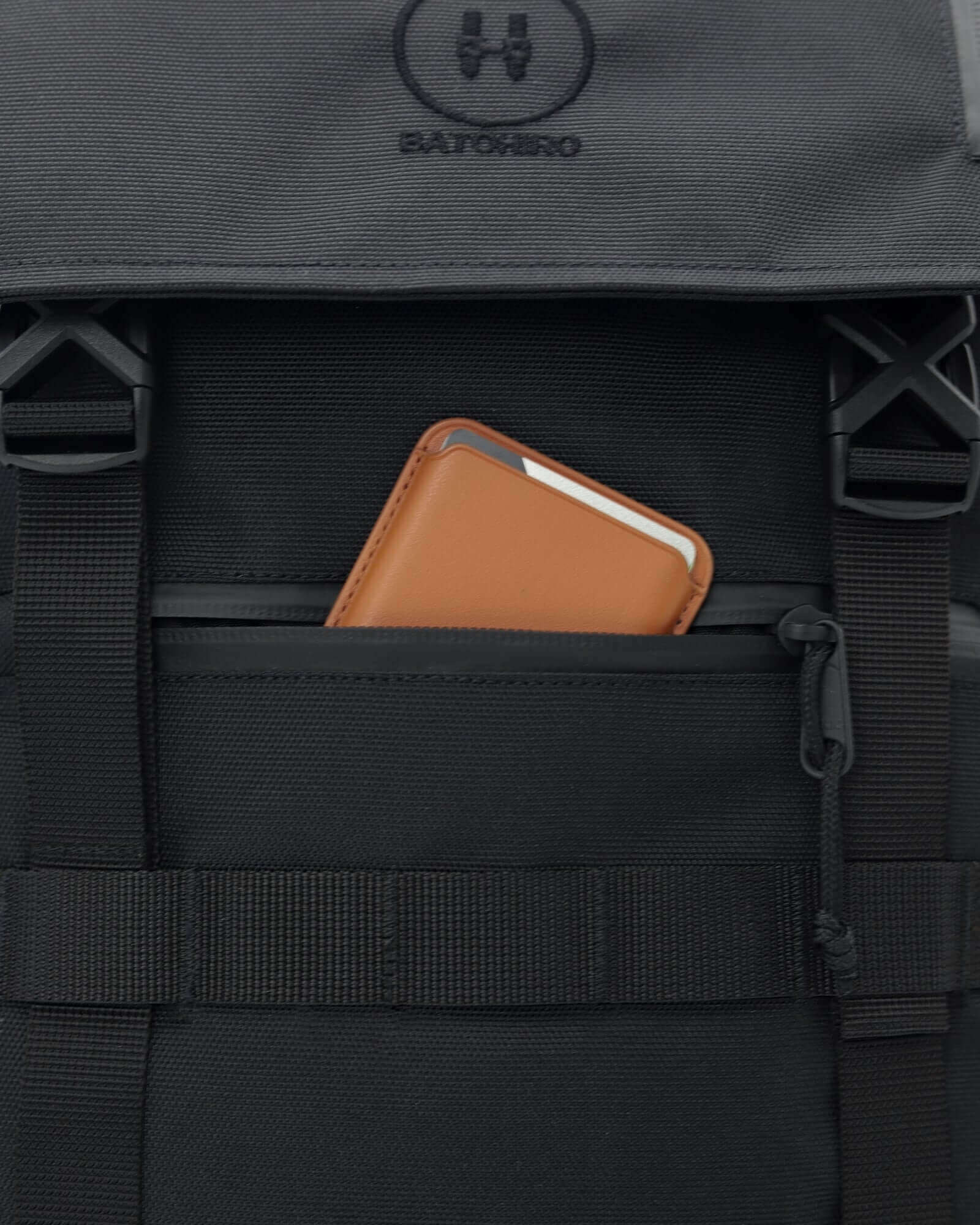 Minato Premium 6.0 – Black Knight backpack pocket with a brown wallet, showcasing functionality and design.