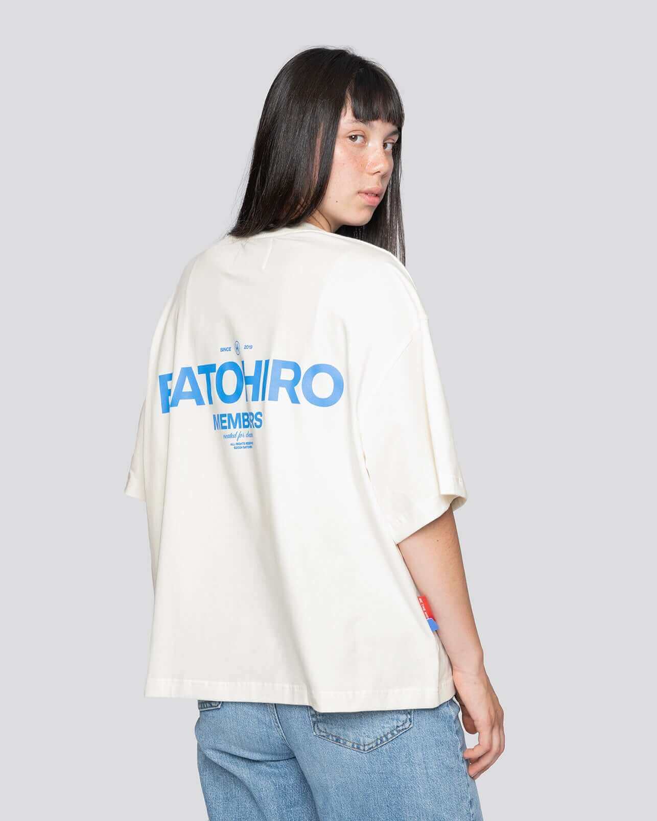 Model wearing a cropped oversized T-shirt with Batohiro branding from the back, showcasing its modern design.