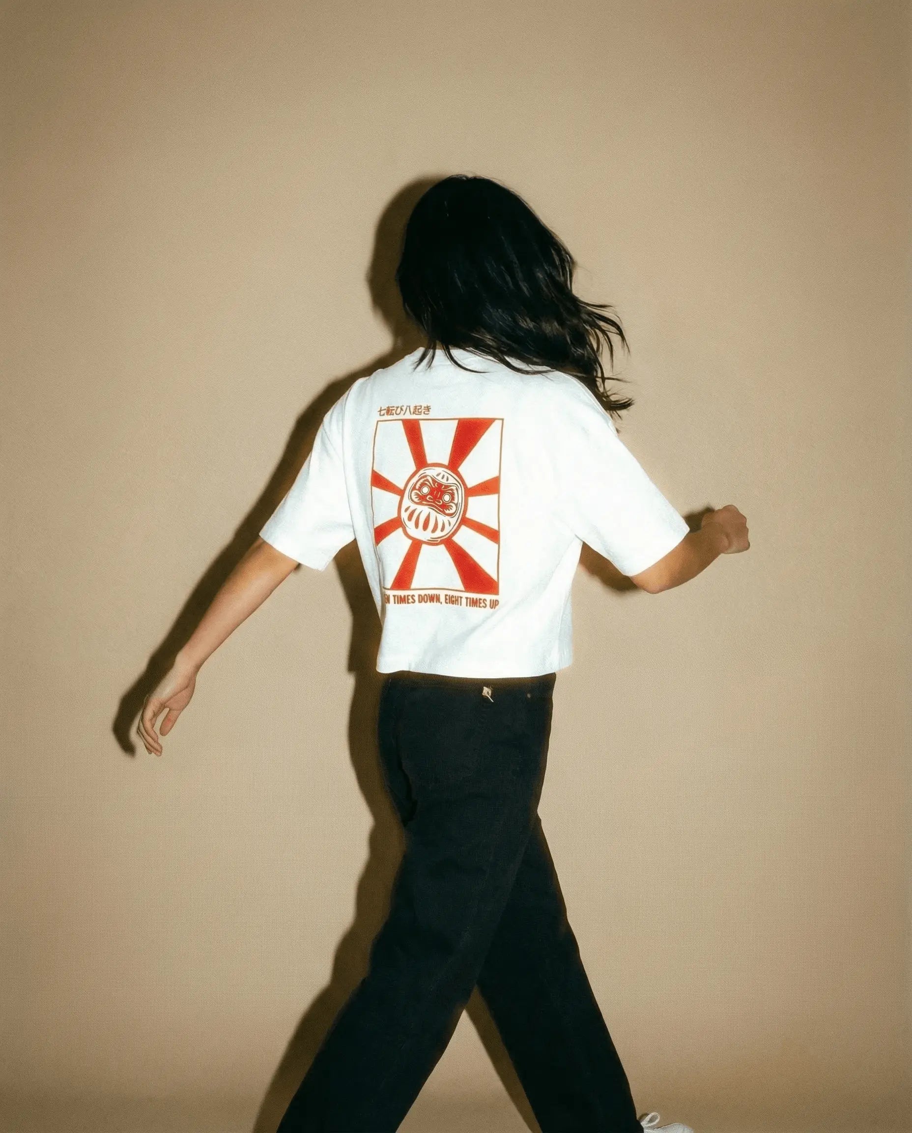 Daruma - White Cropped Oversized Tee worn by model, showcasing embroidered design on front and graphic print on back.