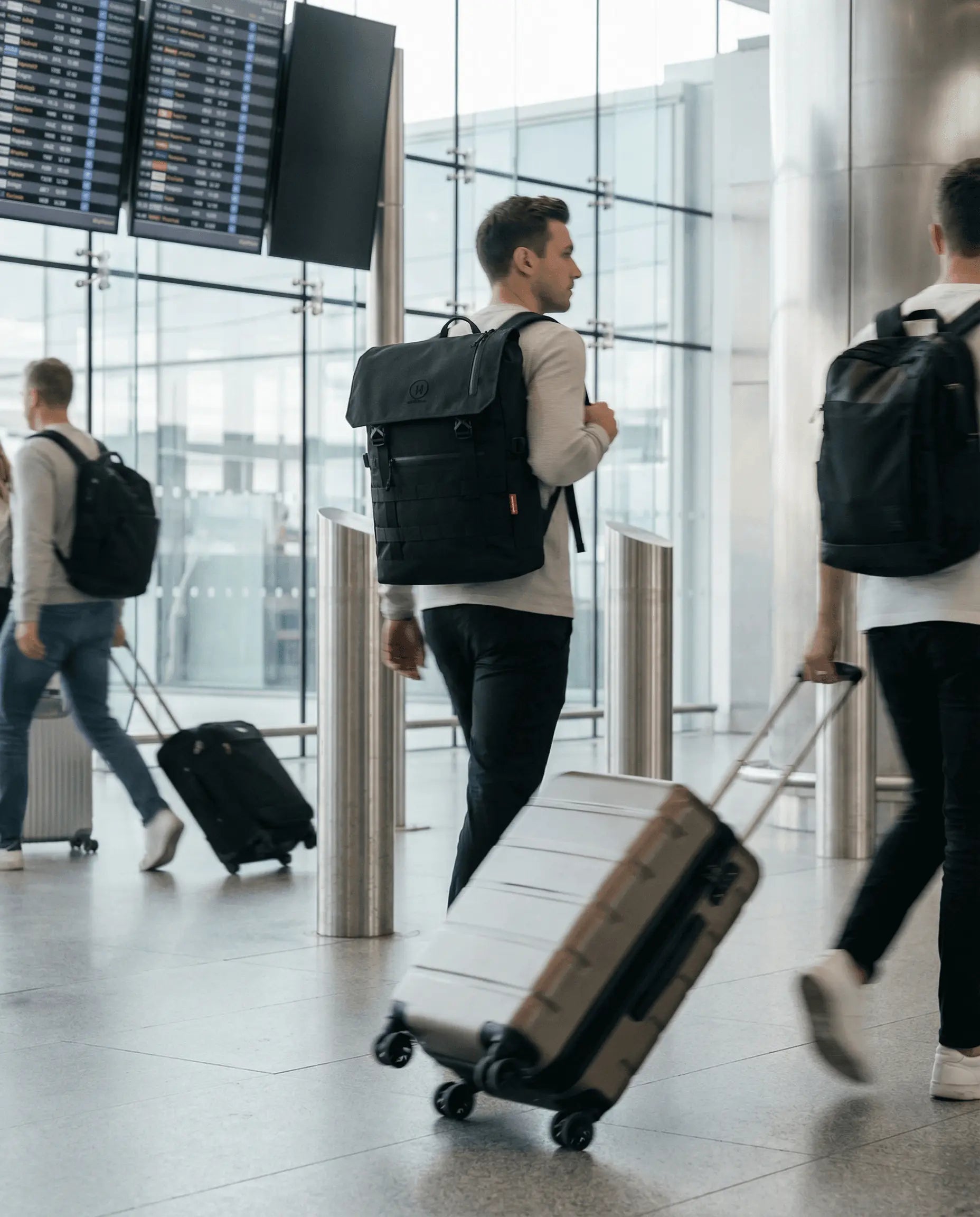 Minato Premium 6.0 – Black Knight backpack at airport, featuring durable design and stylish functionality.
